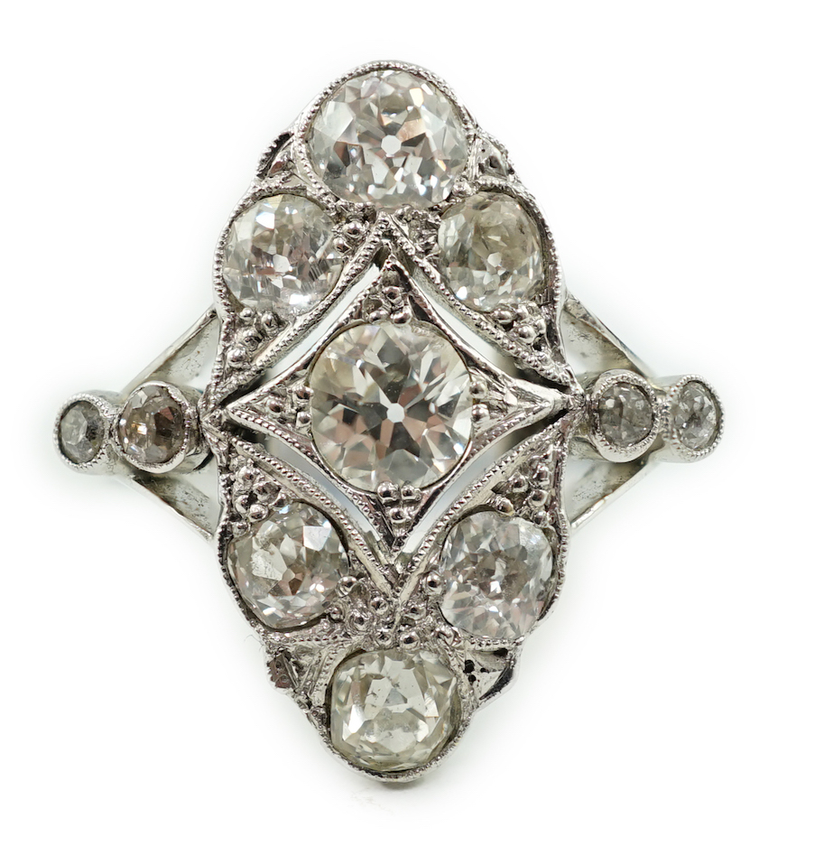 An early 20th century 18ct white gold, platinum and millegrain set old cut diamond cluster ring